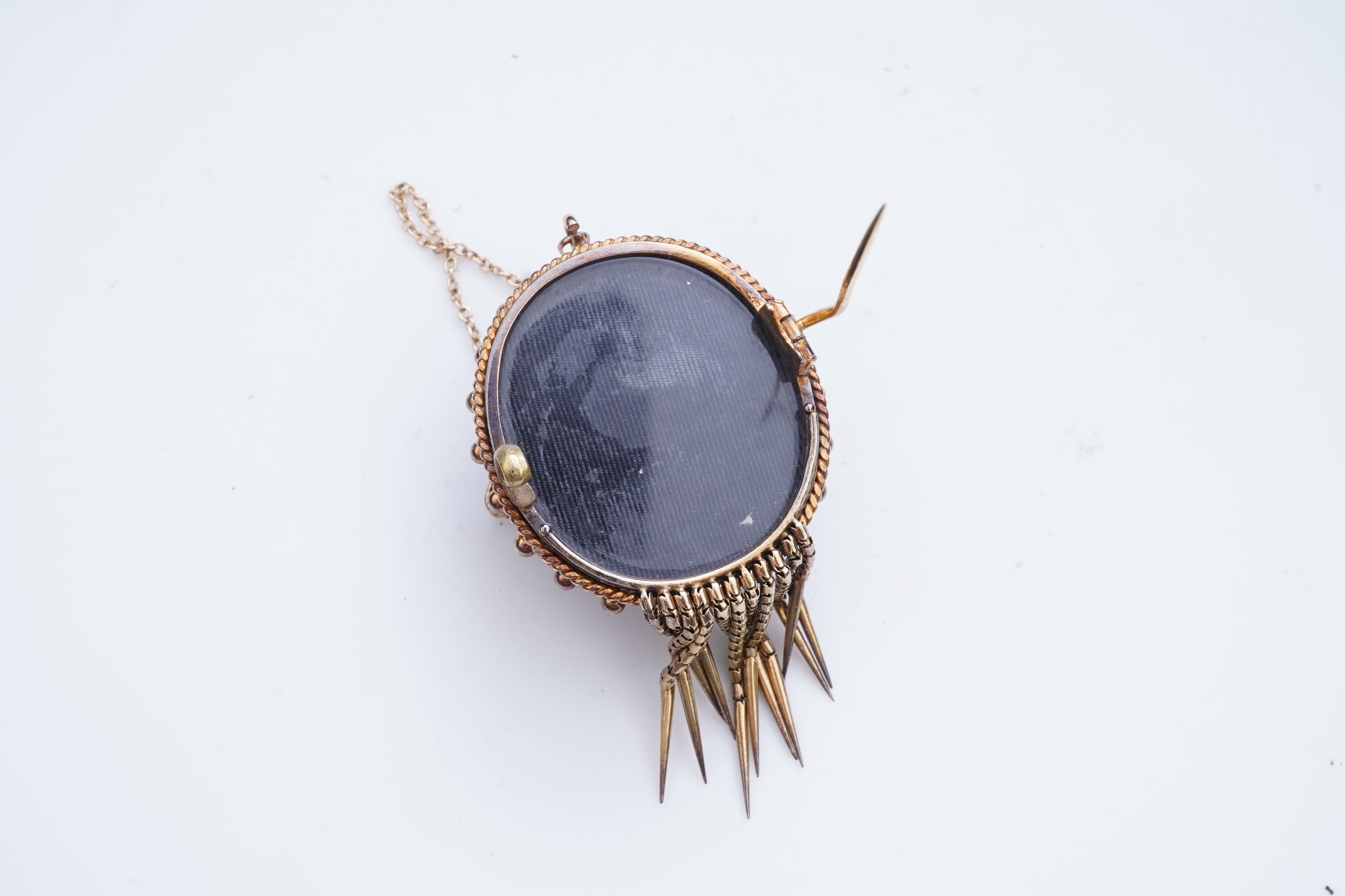 A Victorian garnet and enamel brooch, mid 19th century